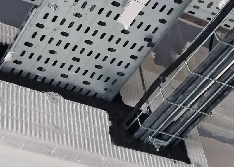 Complex fire stopping by Enclose: a stepped fire batt seal around a cable tray and cable basket passing through a wall